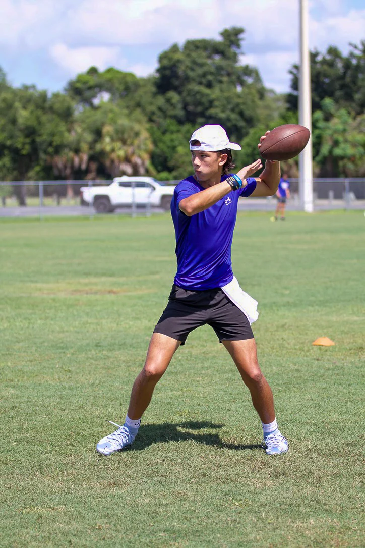 Quarterback throwing across the field