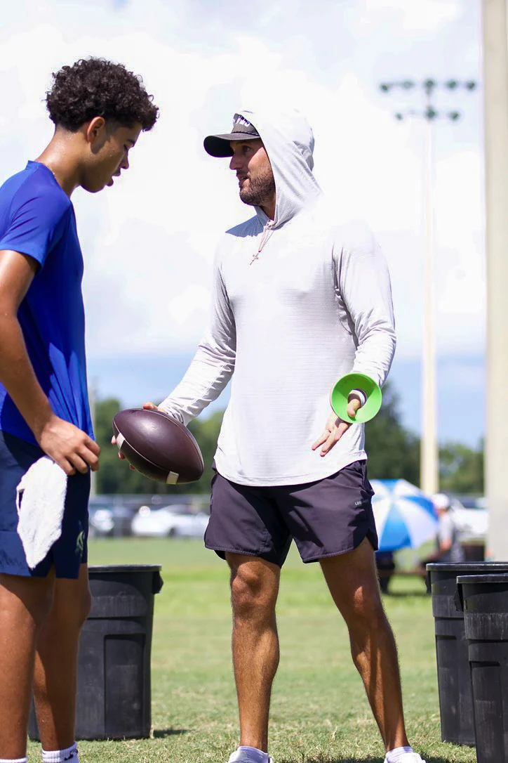 Coach speaking with a quarterback